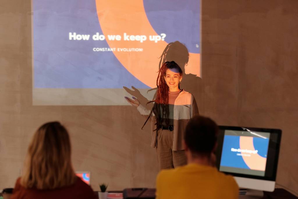 women explaining a topic while presenting